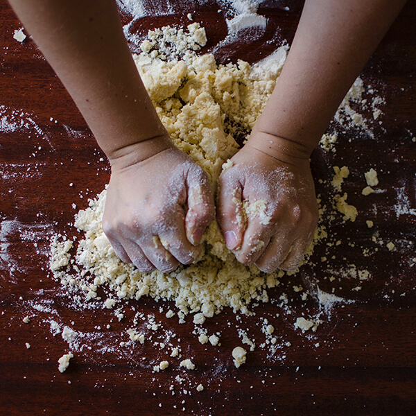 hands kneading dough