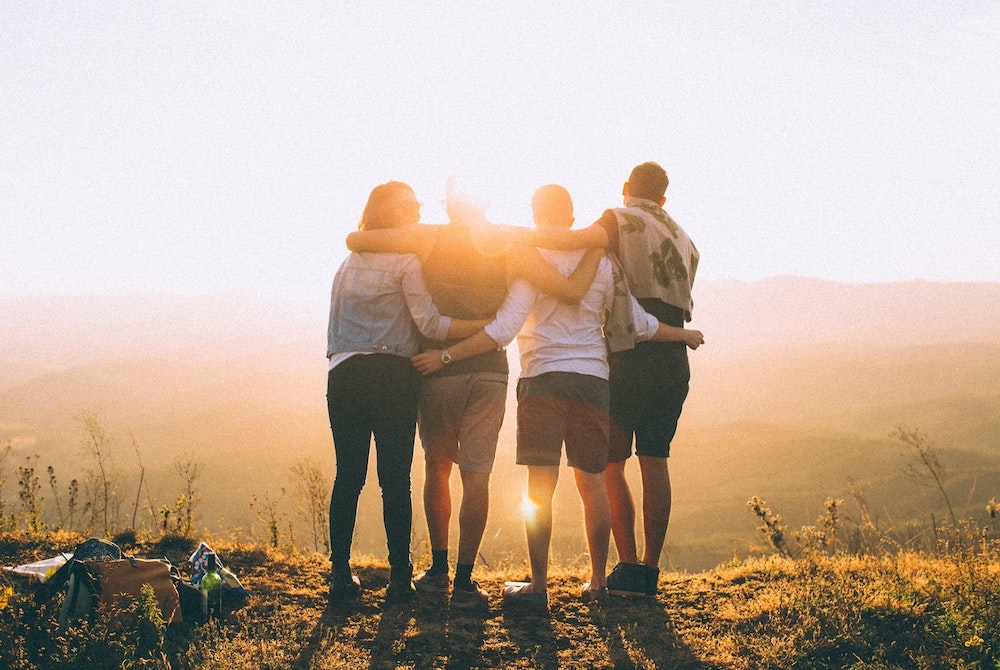 group hugging on cliff