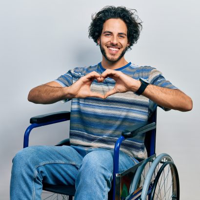 Handsome,Hispanic,Man,Sitting,On,Wheelchair,Smiling,In,Love,Doing