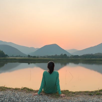 Social,Distancing,,A,Woman,Is,Sitting,Alone,By,The,Lake
